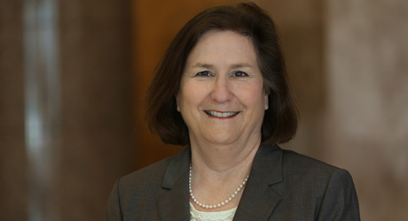 Karen Hetchinson Gordon attorney at Gordon & Sykes smilling head shot woman with short hair pearl necklace
